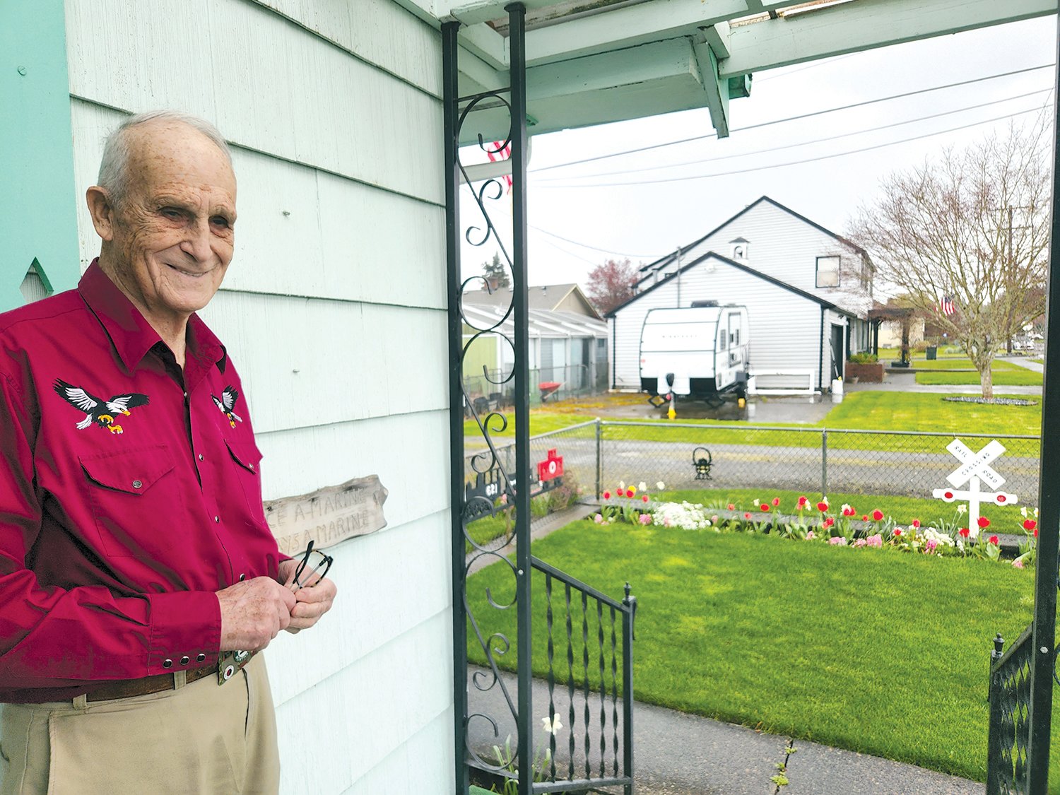 Robert McInnis stands on his porch in the Edison District next to a sign reading “Once a Marine, Always a Marine.”